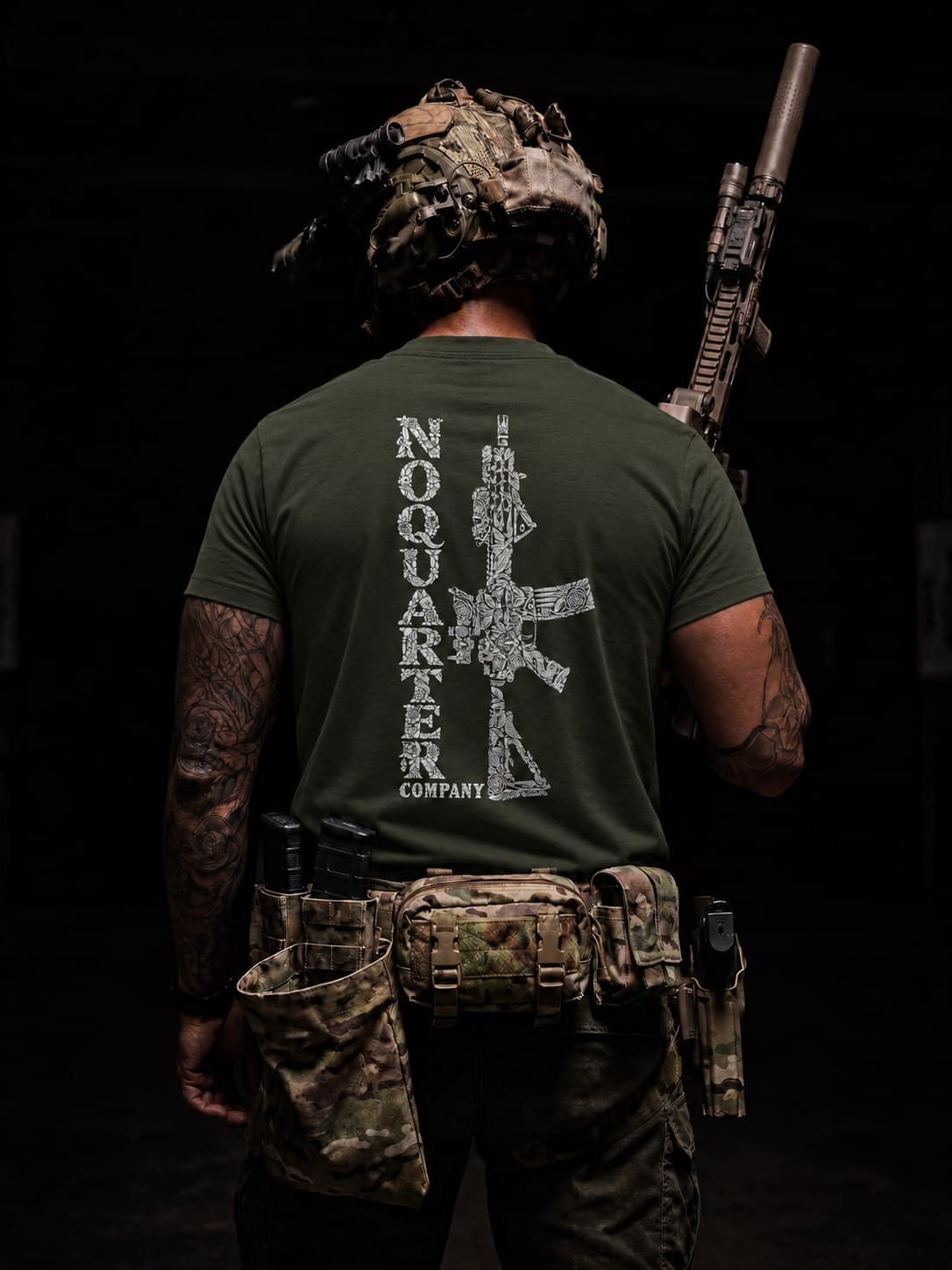 First look at Drop 01: olive tee with the NO QUARTER COMPANY rifle back print, worn by an operator in full kit